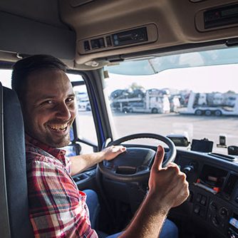 portrait-truck-driver-sitting-his-truck-holding-thumbs-up